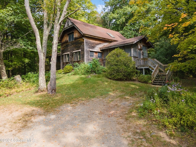 view of property exterior with a lawn