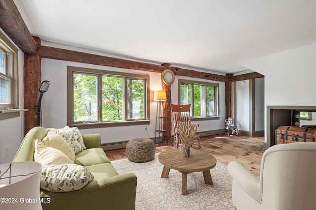 living room with a baseboard heating unit and light wood-type flooring