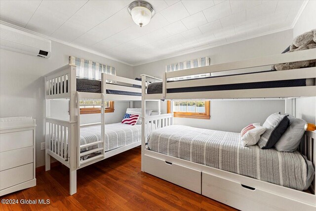 bedroom with crown molding and dark hardwood / wood-style flooring