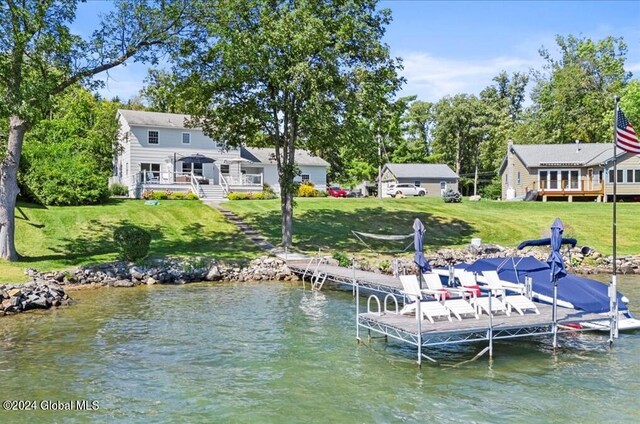 view of dock featuring a water view and a lawn