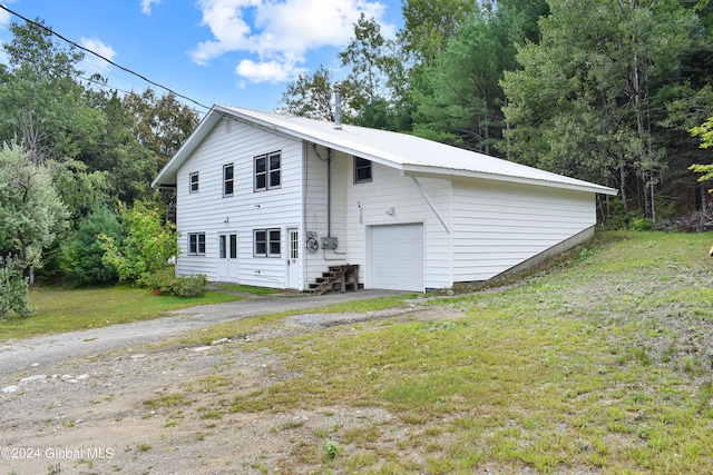 exterior space featuring a garage and a yard