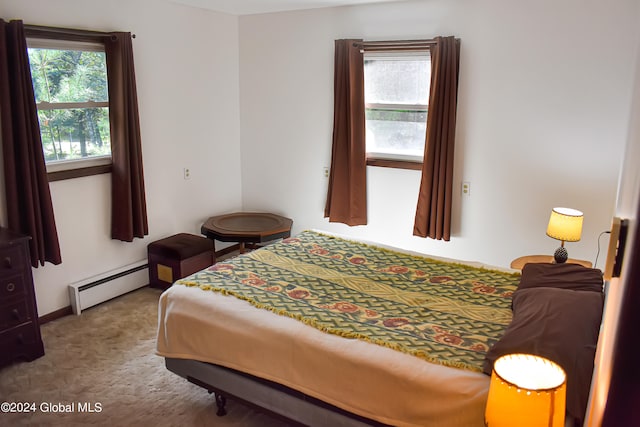 carpeted bedroom with a baseboard heating unit