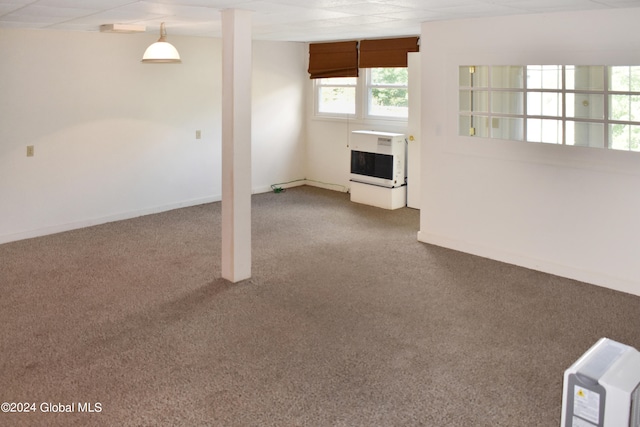 interior space featuring heating unit and carpet