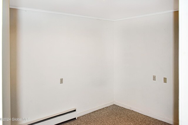 carpeted empty room featuring ornamental molding and a baseboard radiator