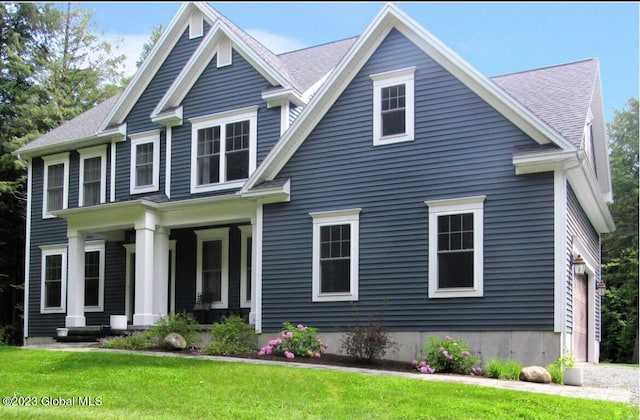 view of front facade with covered porch and a front lawn