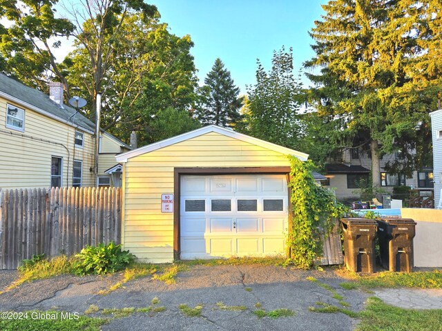 detached garage featuring fence