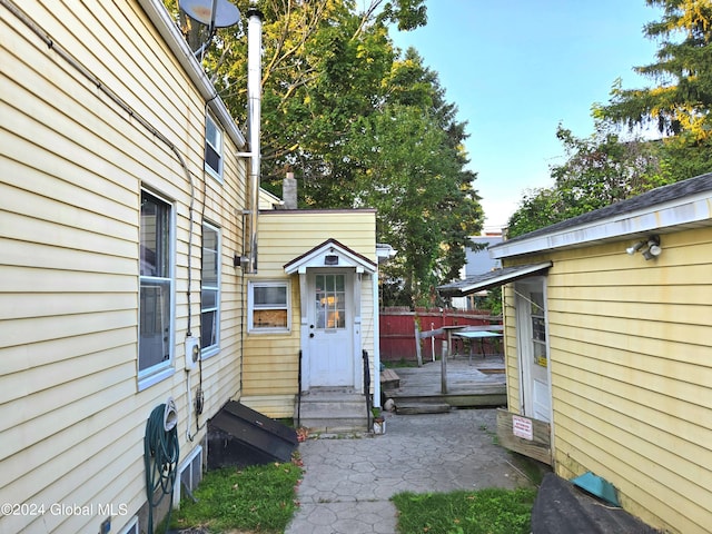 view of exterior entry featuring a deck