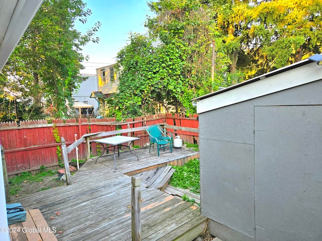 wooden deck featuring a shed