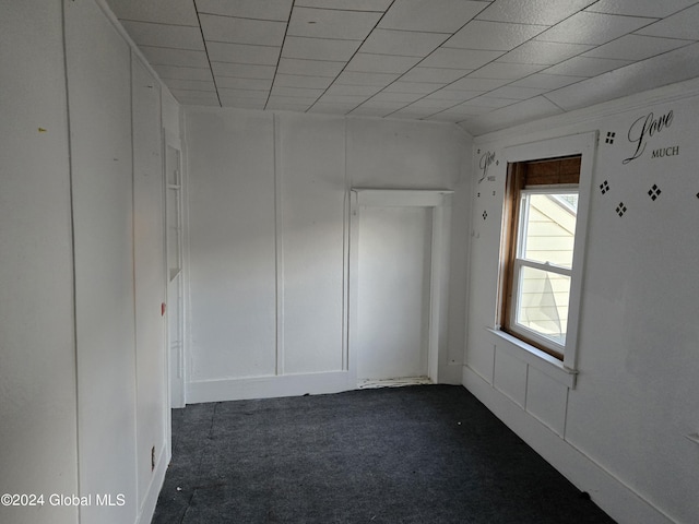 unfurnished room with dark colored carpet