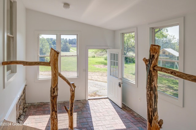 sunroom with lofted ceiling and a healthy amount of sunlight