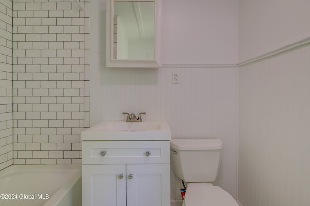 full bathroom featuring tiled shower / bath, toilet, and vanity