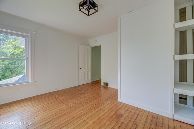 unfurnished room with light wood-type flooring