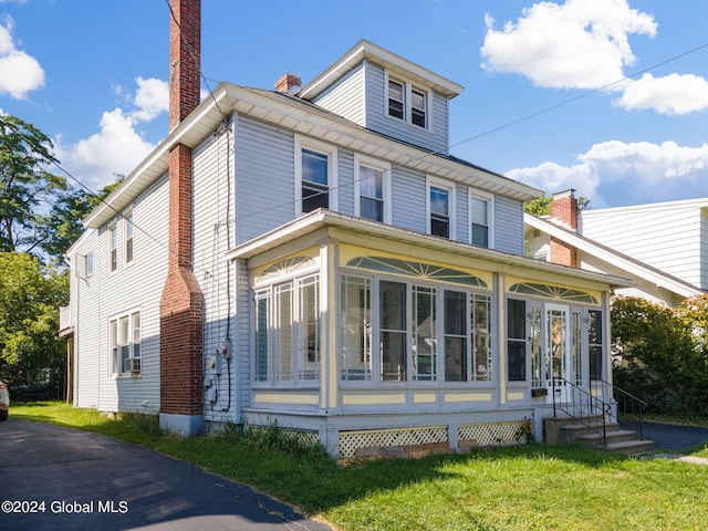 view of front of home with a sunroom