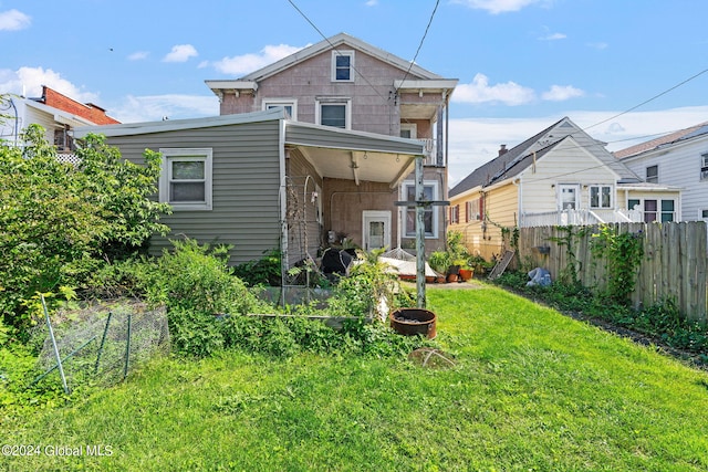 back of house with a yard