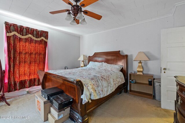 bedroom with ceiling fan, light colored carpet, and ornamental molding