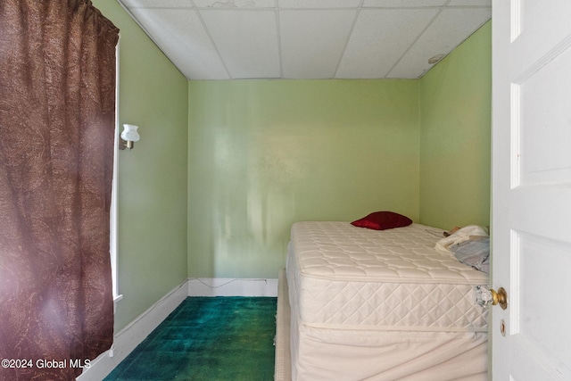 bedroom with a paneled ceiling and carpet flooring