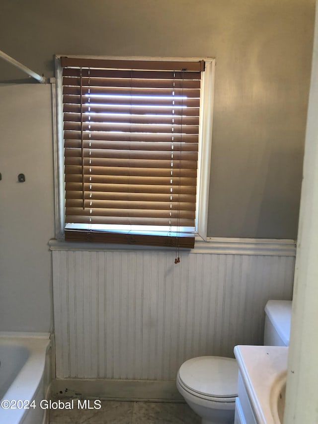 full bath featuring a shower, a wainscoted wall, toilet, vanity, and a tub