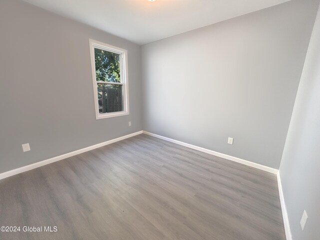 unfurnished room featuring dark hardwood / wood-style flooring