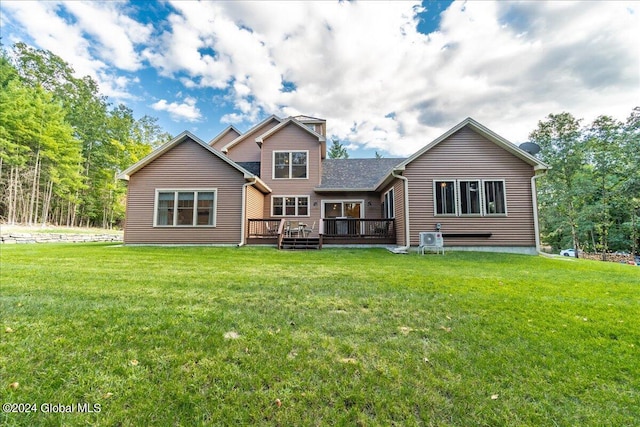 rear view of property with a lawn and a deck