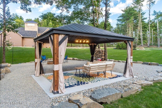 view of home's community with a gazebo, an outdoor living space, a patio, and a yard