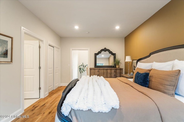 bedroom featuring light wood-type flooring and a closet