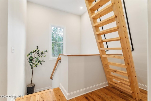 staircase featuring hardwood / wood-style flooring