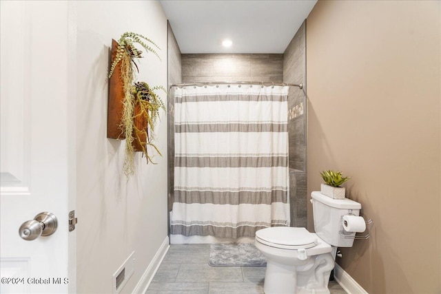 bathroom featuring tile patterned flooring, toilet, and shower / tub combo with curtain