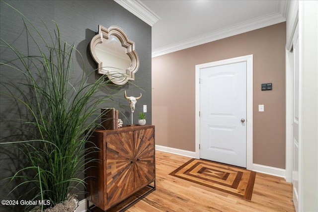 foyer featuring light wood-type flooring and crown molding