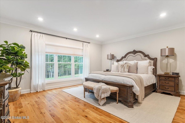 bedroom with ornamental molding and light wood-type flooring