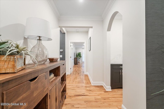 hallway with crown molding and light wood-type flooring