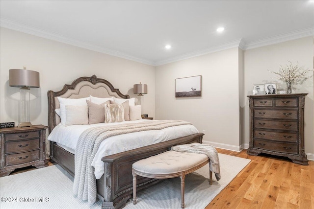 bedroom featuring crown molding and light hardwood / wood-style flooring