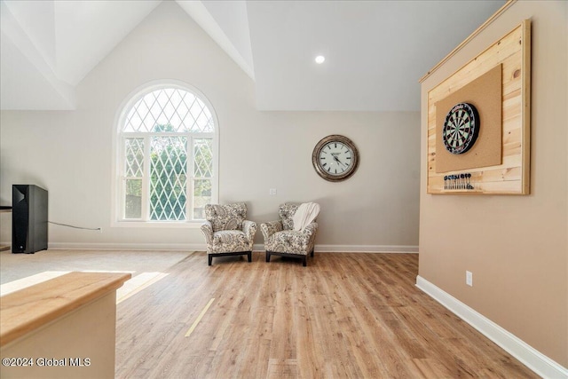 living area featuring light hardwood / wood-style flooring and vaulted ceiling