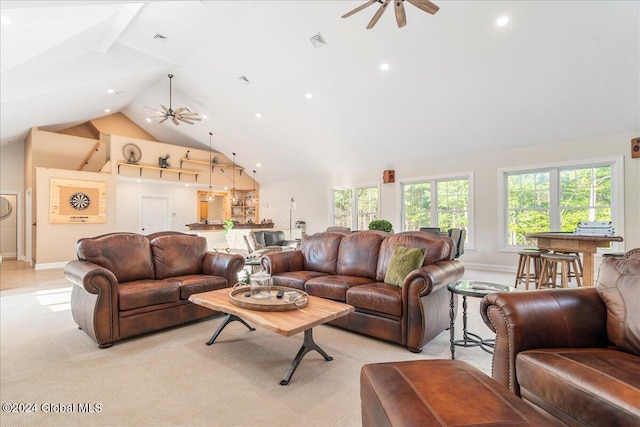 living room featuring light colored carpet, high vaulted ceiling, ceiling fan, and a healthy amount of sunlight