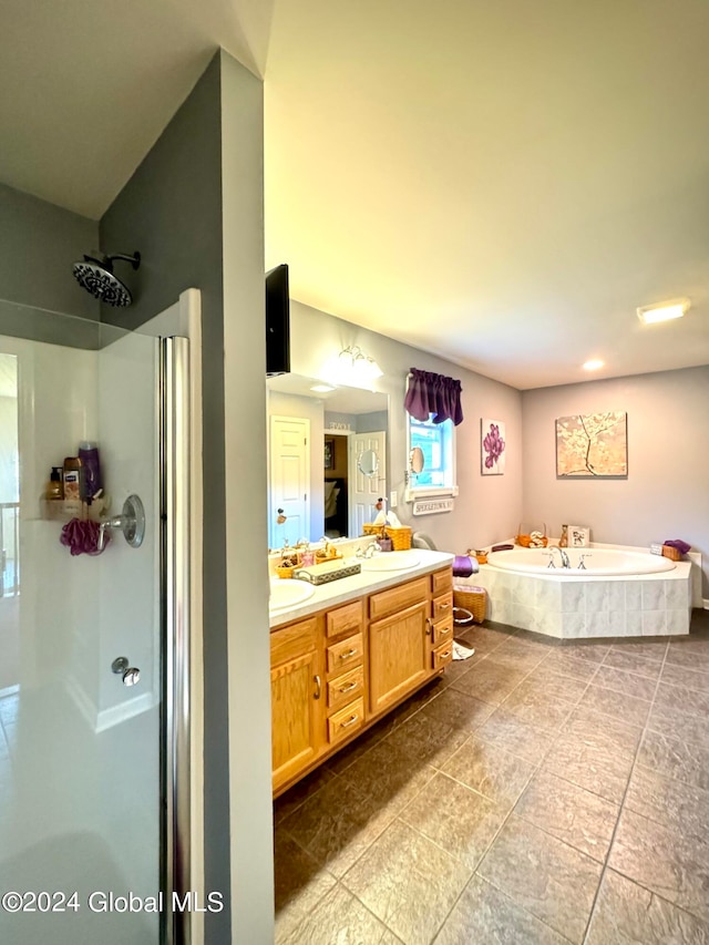 bathroom featuring vanity and separate shower and tub