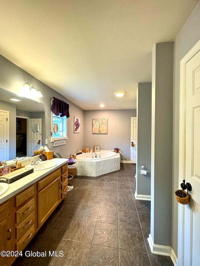 bathroom featuring a tub to relax in and vanity