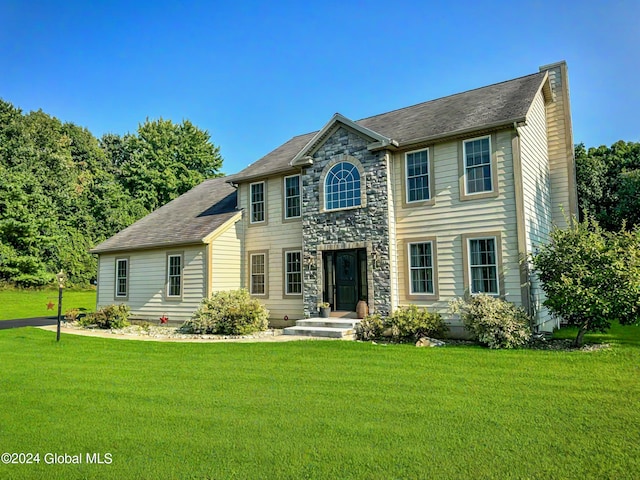 colonial inspired home with a front yard