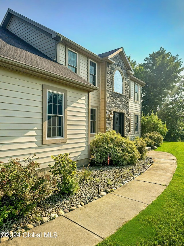 view of side of property with a yard