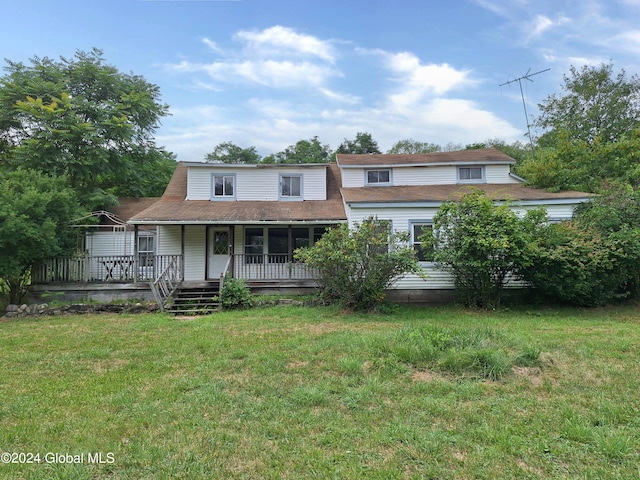 view of front of property with a front yard and a deck