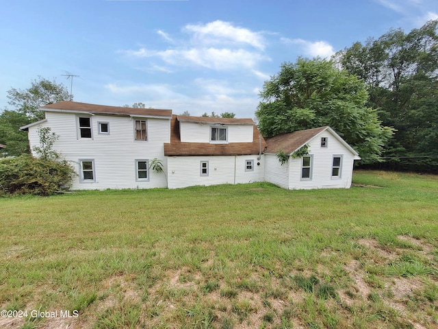 back of property featuring a lawn