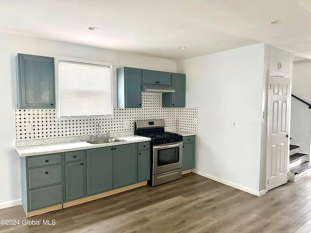 kitchen with sink, dark wood-type flooring, tasteful backsplash, stainless steel range with gas stovetop, and green cabinetry