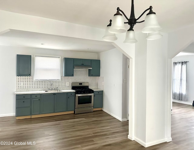 kitchen with stainless steel stove, plenty of natural light, dark hardwood / wood-style floors, and sink