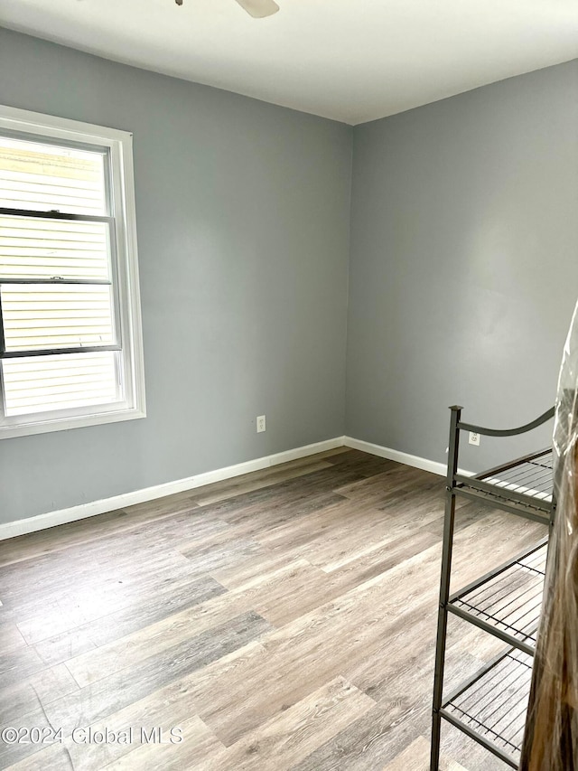 unfurnished room with light wood-type flooring and ceiling fan