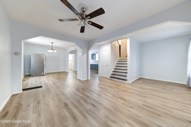 unfurnished living room featuring light wood-type flooring and ceiling fan