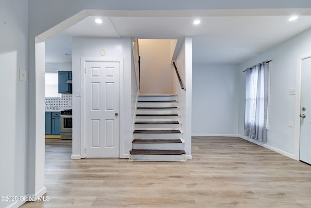 staircase with hardwood / wood-style flooring