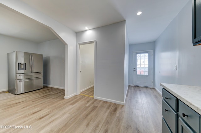 kitchen with light wood-type flooring and stainless steel refrigerator with ice dispenser