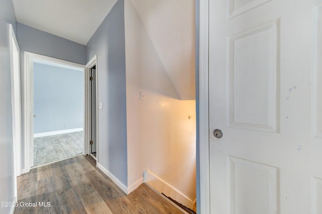 hall featuring lofted ceiling and light wood-type flooring