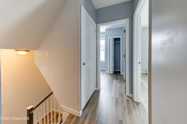 corridor with light hardwood / wood-style floors