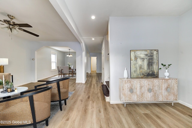 hall featuring a notable chandelier and light wood-type flooring