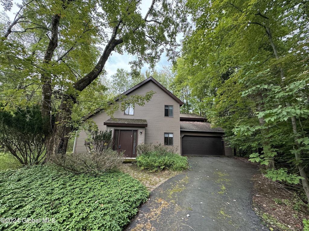 view of front of property with a garage and aphalt driveway
