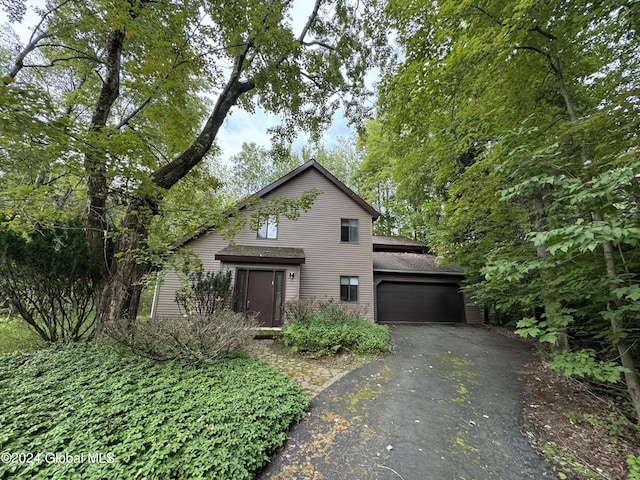 view of front of property with a garage and aphalt driveway